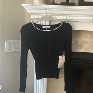 Black ribbed long sleeve sweater with pearl embellished neckline
